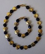 A Necklace and Bracelet Set With Rare, Natural, Black, Round Flat Pearls