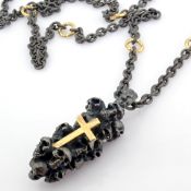 An Exquisite Cross On Skulls Necklace Detailed With Brilliant Diamonds and Gold On Silver.