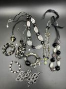 A collection of costume jewellery, charm bracelets, necklaces and earrings