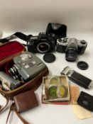 A small selection of 35mm cameras to include a Pentax, Canon and a cine camera.