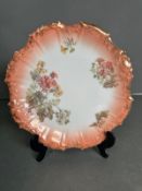 A Coiffe of Limoges plate (1891-1914) in peach with floral decoration 24cm diameter