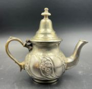 A white metal Arabic tea pot
