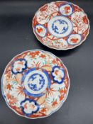 A pair of Imari plates with scallop edge