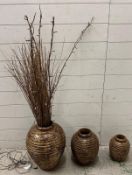 Three gold and black ribbed graduated vases