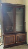 A substantial mahogany display cabinet with glazed doors and a two door cupboard under (H228cm