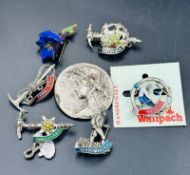 A selection of vintage mountaineering type badges and pins.