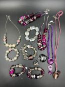 A collection of costume jewellery, charm bracelets, beaded bracelets and string necklaces
