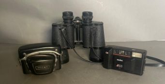 A pair of Hans Weiss field glasses along with a Halina camera and a pacer camera.