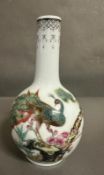 A bottle nosed Chinese vase with peacock decoration