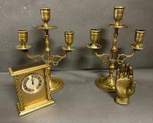 A selection of brass items to include a Swiza clock and a pair of candlesticks