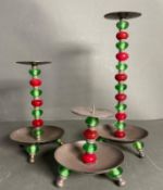 Three white metal candle sticks in various sizes with red and glass beaded stems