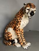 A seated ceramic Cheetah with repairs to legs H43cm