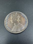 An 1862 One Rupee Indian coin.