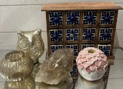 A collection of ceramic and glass objects including drawers