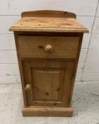 A pine single drawer bedside table with cupboard under and galleried top (H66cm W36cm D31cm)