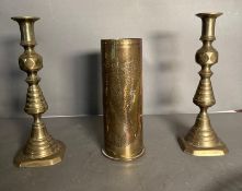 A pair of brass candlesticks, a trench Art shell and a white metal platter