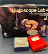 A Thomas Salter Microscope Lab $ along with several boxes of slides, including prepared slides of