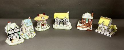 Six Coalport ornamental houses decorated with bocage to include, Thatched Cottage, The Old Curiosity