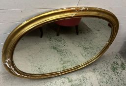 A substantial oval gilt wall mirror, plaster frame AF (Frame 102cm x 128cm)