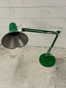 An angle poise lamp in green