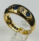 An 18ct gold sapphire and diamond gypsy ring approximate size ).5 and weight 7.2g
