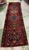 A red ground runner 320cm x 102cm
