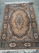 A wool rug, brown grounds with central medallion and geometric boarder 200cm x 140cm