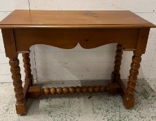 A side table on bobbin style legs (H76cm W100cm D44cm)