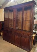 Elegant English Georgian style bookcase, deep moulded cornice four glazed doors sitting over four