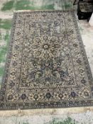 A green and blue rug with a central medallion 250cm x 160cm