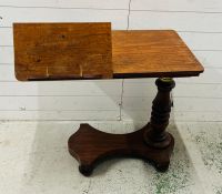A mahogany Revival twin reading table with a double book rest, adjustable turned stem on a solid