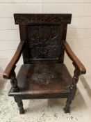 An oak Wainscot hall chair with carved back