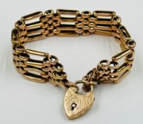 A 9ct gold gate bracelet with a heart shaped fastener with approximate total weight 24g