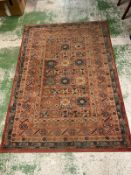 A red and blue rug with multiply boarder 200cm x 140cm