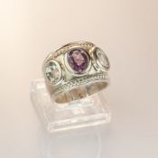 Oval amethyst and aqua dress ring set with one oval amethyst 1.20ct and flanked by two oval