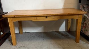 A light oak kitchen or dining table with single short drawer to centre (H77cm W180cm D90cm)
