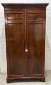 A mahogany two door wardrobe, brass cross rail internal mirror (H208cm W111cm D56cm)