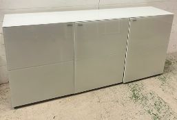 A white gloss long sideboard with press close doors opening to shelves (H82cm W180cm D40cm)