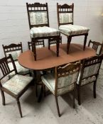 A mahogany dining table with a set of chairs