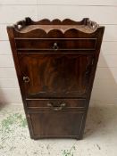 A mahogany bedside cabinet, gallery top with hand cut outs opening to slide pull out stand and