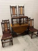 Six oak dining chairs with leather seat and cane back along with barley twist dining table
