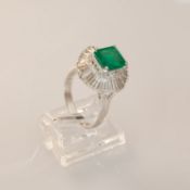 An emerald and diamond ballerina style cluster ring, emerald cut emerald, approximately 2.25