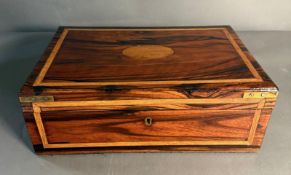 A coromandel wood campaign style box with brass handles and blank central escutcheon