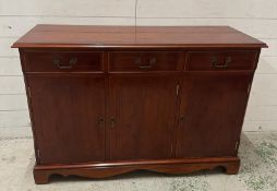A yew veneered sideboard comprising of three door cupboards and three short drawers (H82cm W120cm