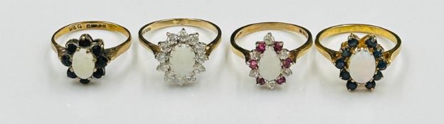 A selection of four opal themed rings in daisy styles all in 9ct yellow gold settings, approximate