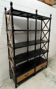 Ebonised bookshelf with cross stretcher sides and drawers to base (H194cm W140cm D42cm)