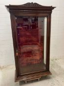 A mahogany glazed display cabinet with arch pediment and velvet back and glass shelves (H194cm