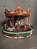 A Lemax Santa Carousel , sights and sounds i original box.