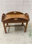 A mahogany butlers tray table (H60cm W80cm D51cm)