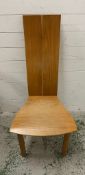 A sculptural high back dining/office chair